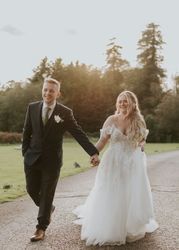Bride and groom walking up driveway