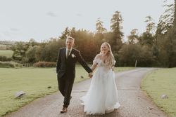 Bride and groom walking up driveway