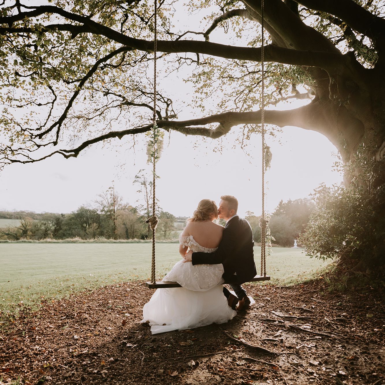 Bride and groom on swing outside