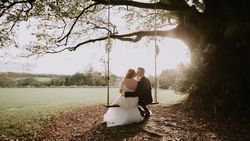Bride and groom on swing outside