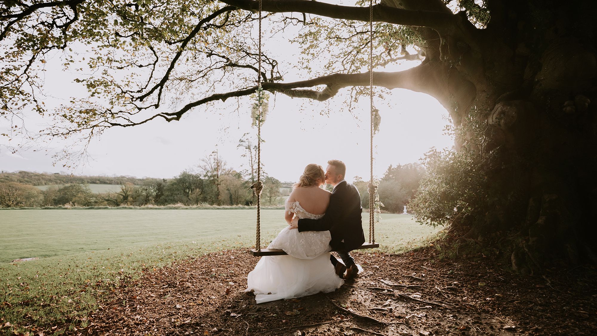 Bride and groom on swing outside