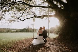 Bride and groom on swing outside