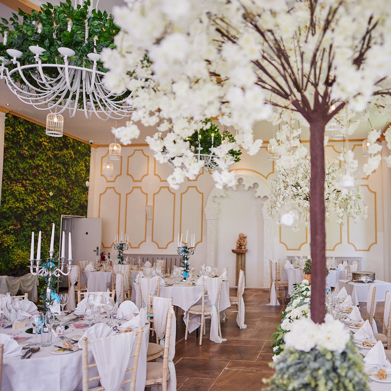 Reception tables set up with white trees