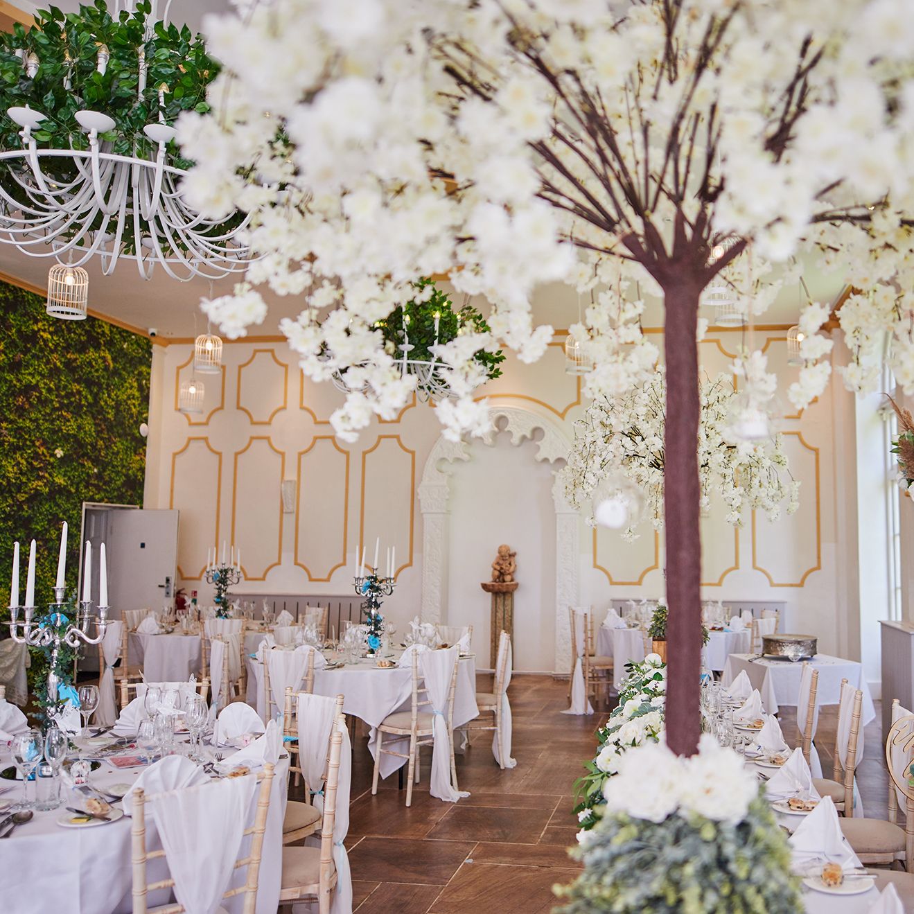 Reception tables set up with white trees