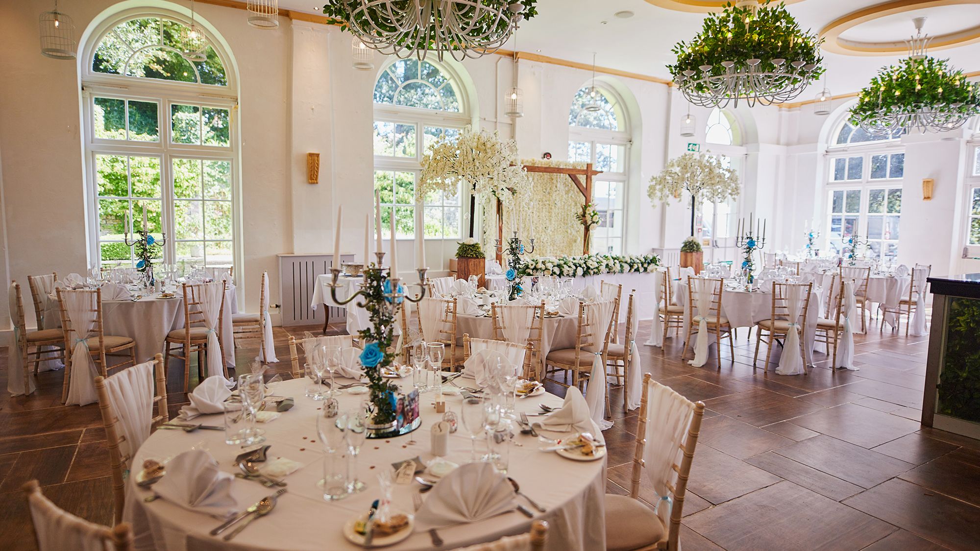 Reception tables set up with white trees