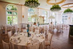 Reception tables set up with white trees