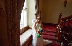 Bride and groom on indoor staircase