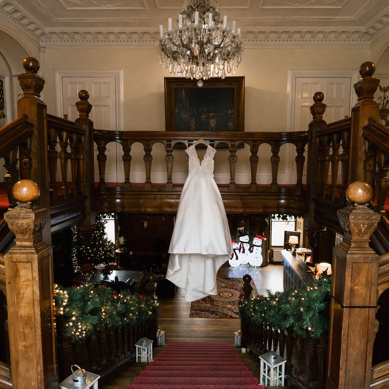 Wedding dress hanging from stairs, with Christmas decorations
