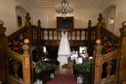 Wedding dress hanging from stairs, with Christmas decorations