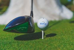 Close-up of a golf club and golf ball on a tee