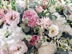 Beautiful arrangement of pink, white, and blush flowers with greenery.