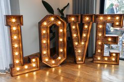 Large illuminated wooden letters spelling out the word LOVE