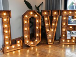 Large illuminated wooden letters spelling out the word LOVE