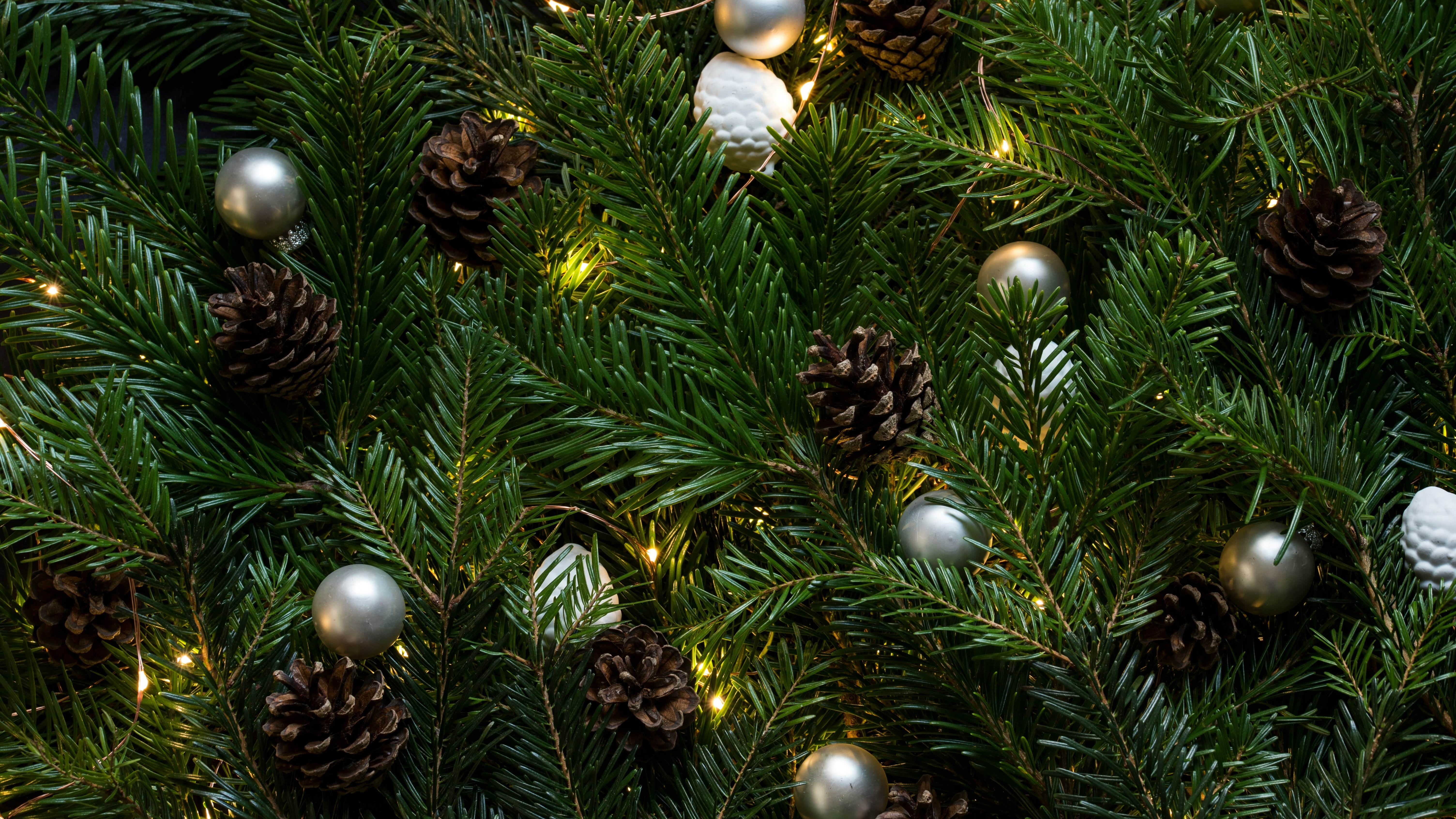 Close-up of decorated Christmas tree branches with pine cones and ornaments