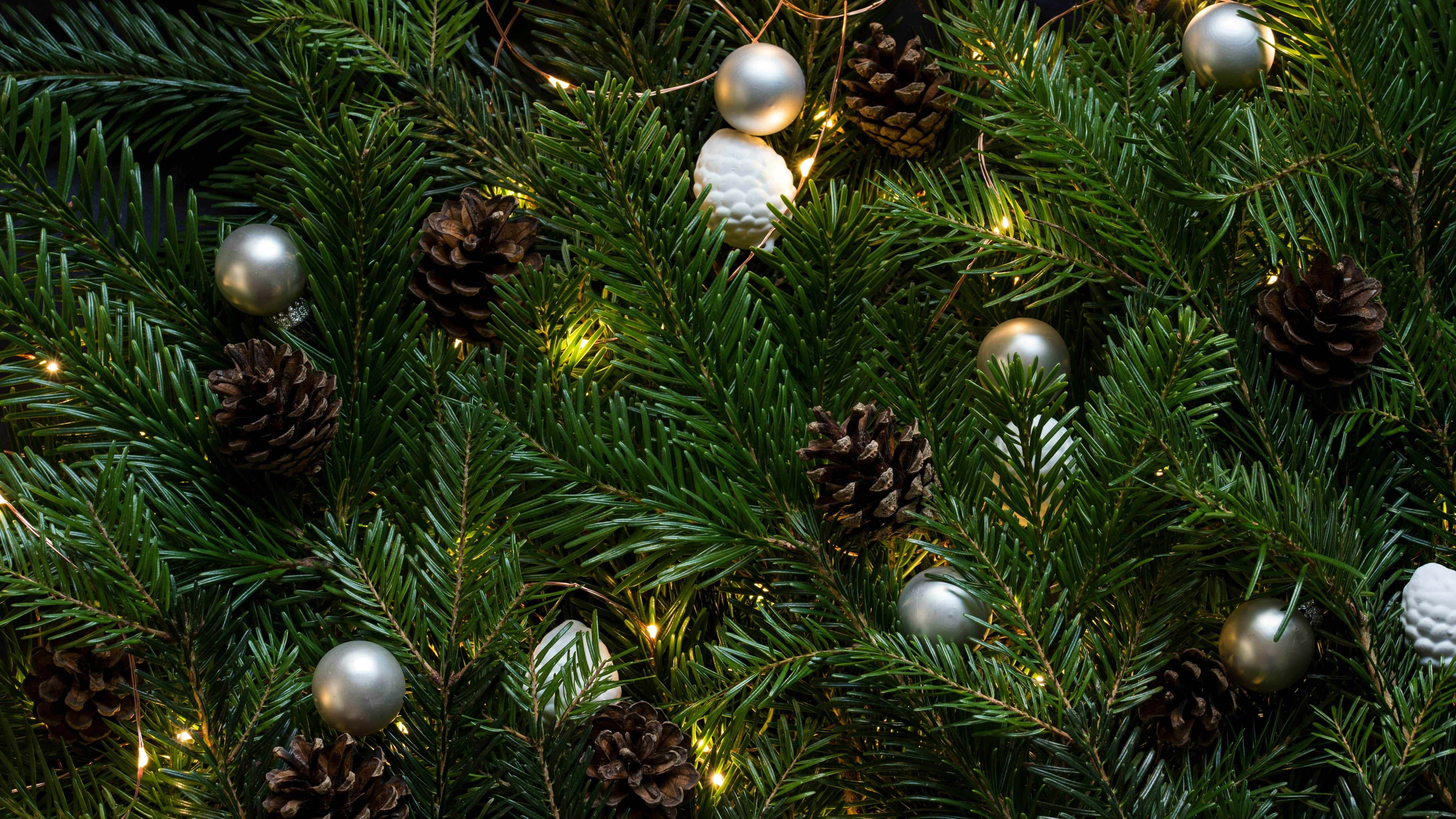 Close-up of decorated Christmas tree branches with pine cones and ornaments