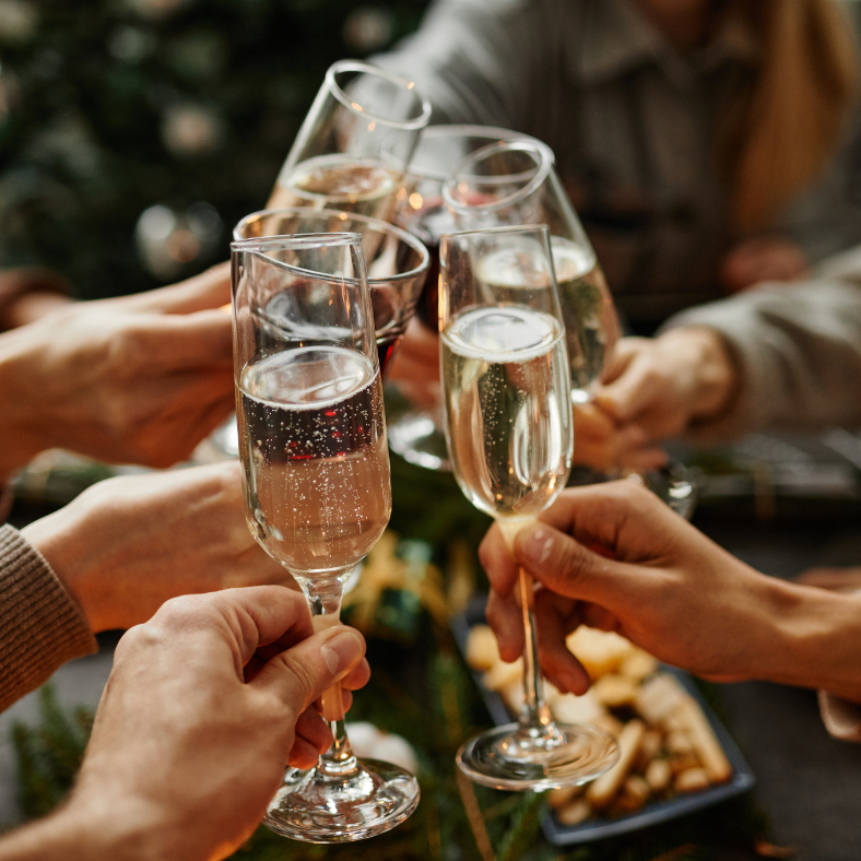 Group of people clinking champagne glasses in a toast