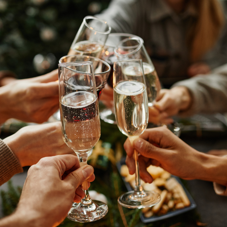 Group of people clinking champagne glasses in a toast