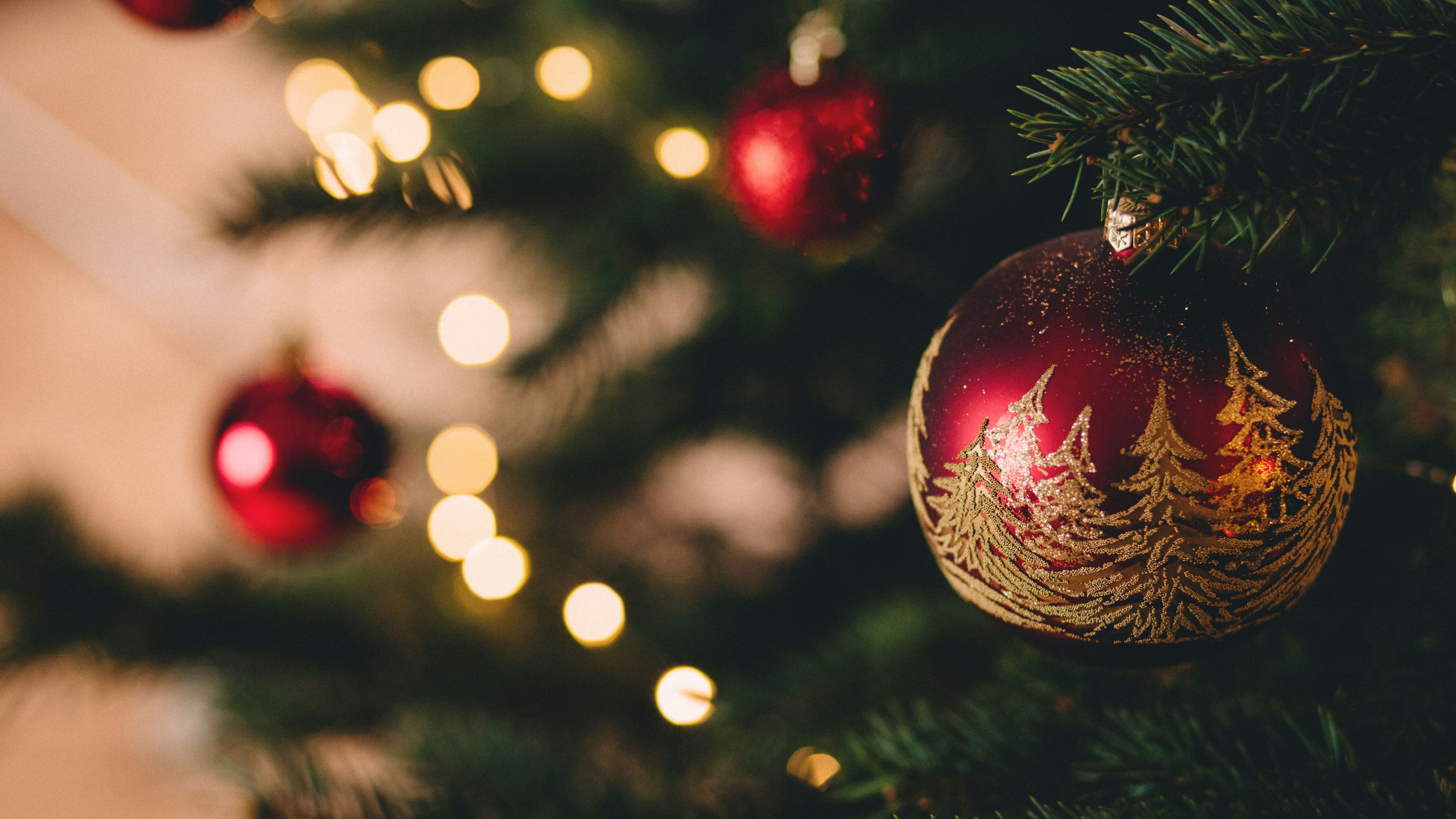 Close-up of Christmas tree decorated with red and gold ornaments and lights