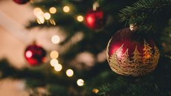 Close-up of Christmas tree decorated with red and gold ornaments and lights