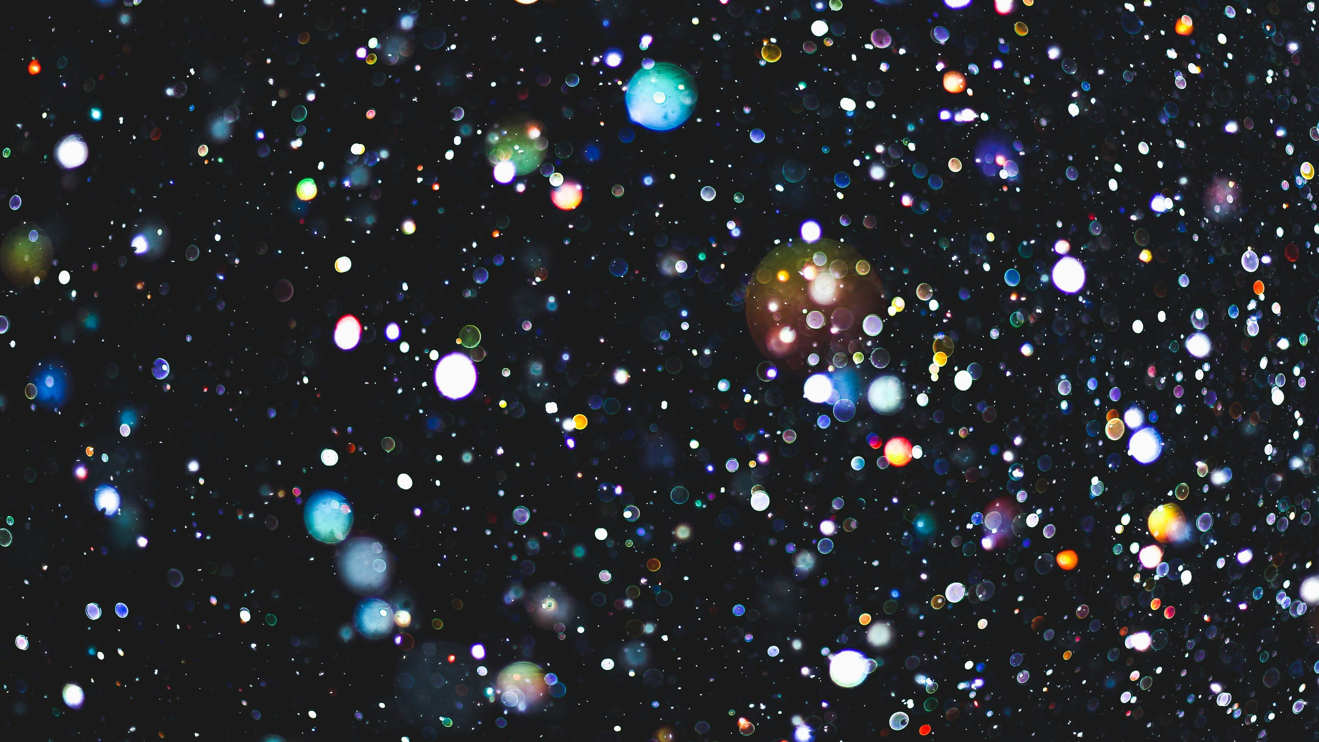 Abstract bokeh lights scattered across a dark background