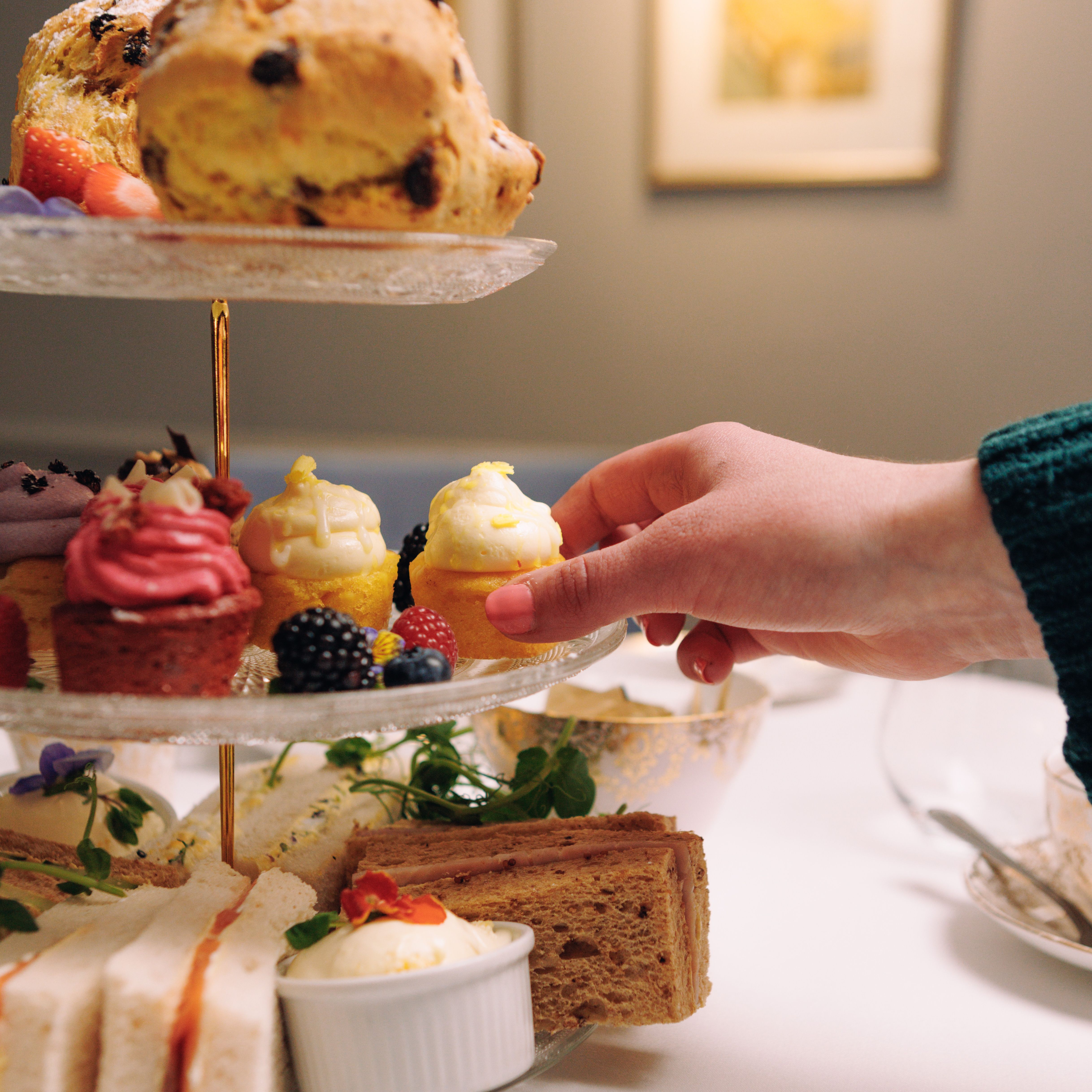 Afternoon Tea with Hand Reaching for Cupcake