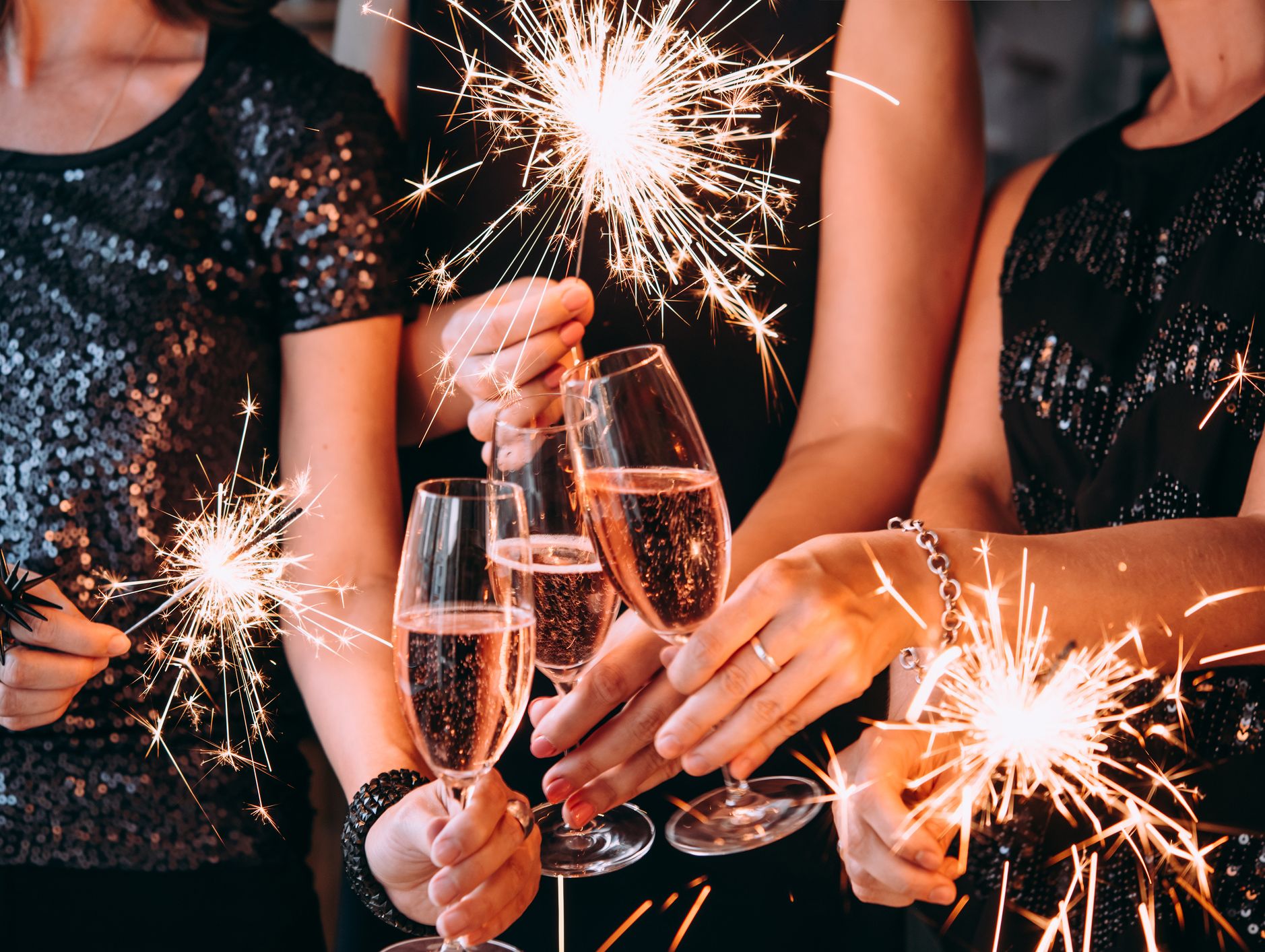 People with glasses of prosecco and sparklers