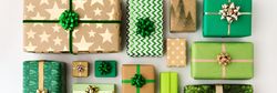 Assorted green and gold wrapped gifts with decorative bows arranged on a white background.