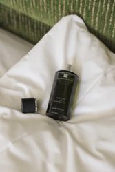 Templespa Quietude sleep well mist bottle on a white bed with the cap off