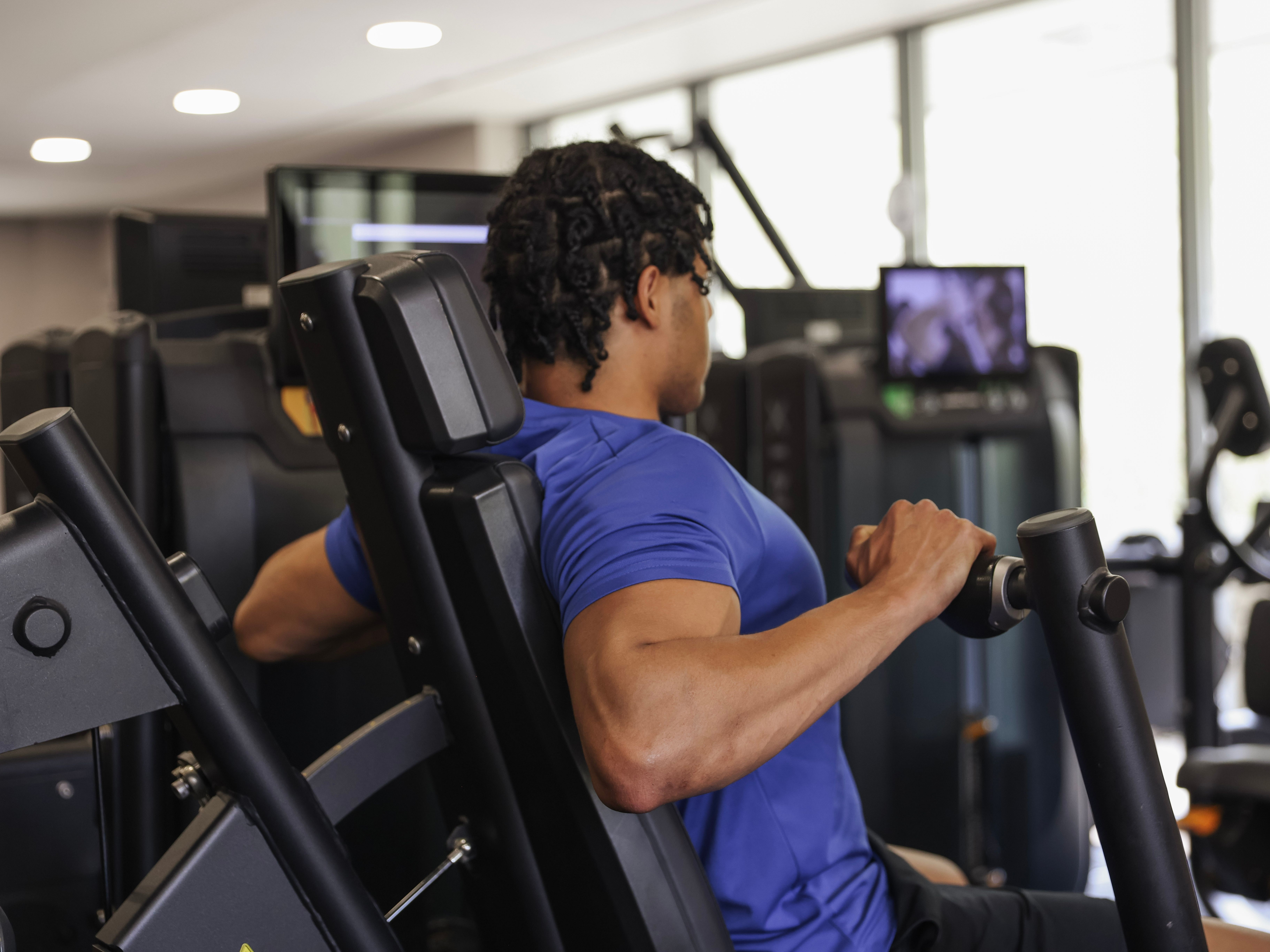 Person working out on a seated machine in a gym