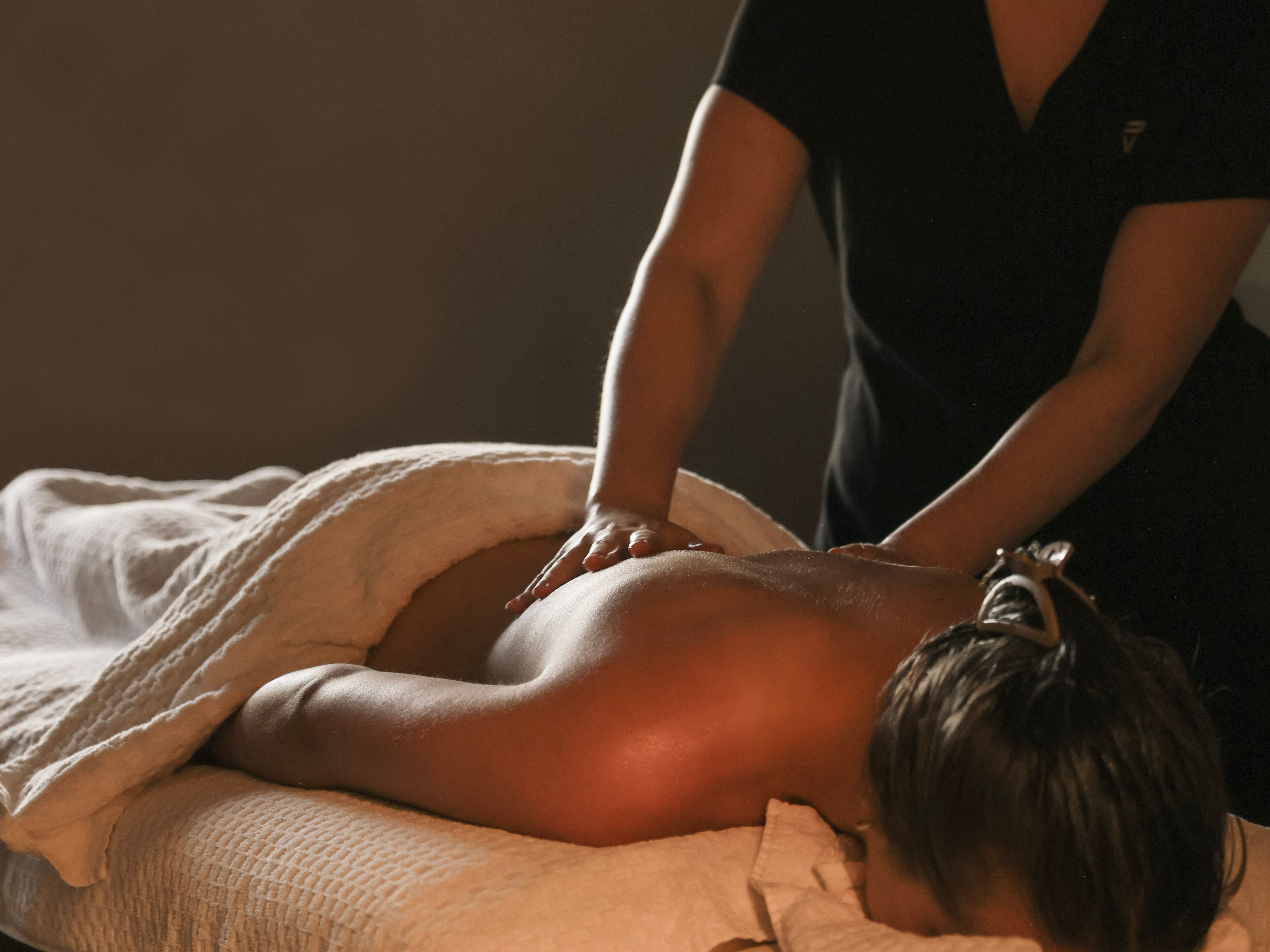 Person receiving a back massage at a spa
