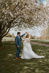 Bride and groom dancing under a blooming tree outdoors