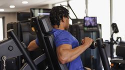 Person using a gym machine for upper body workout