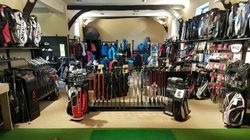 Golf shop interior with clubs, bags, and clothing on display