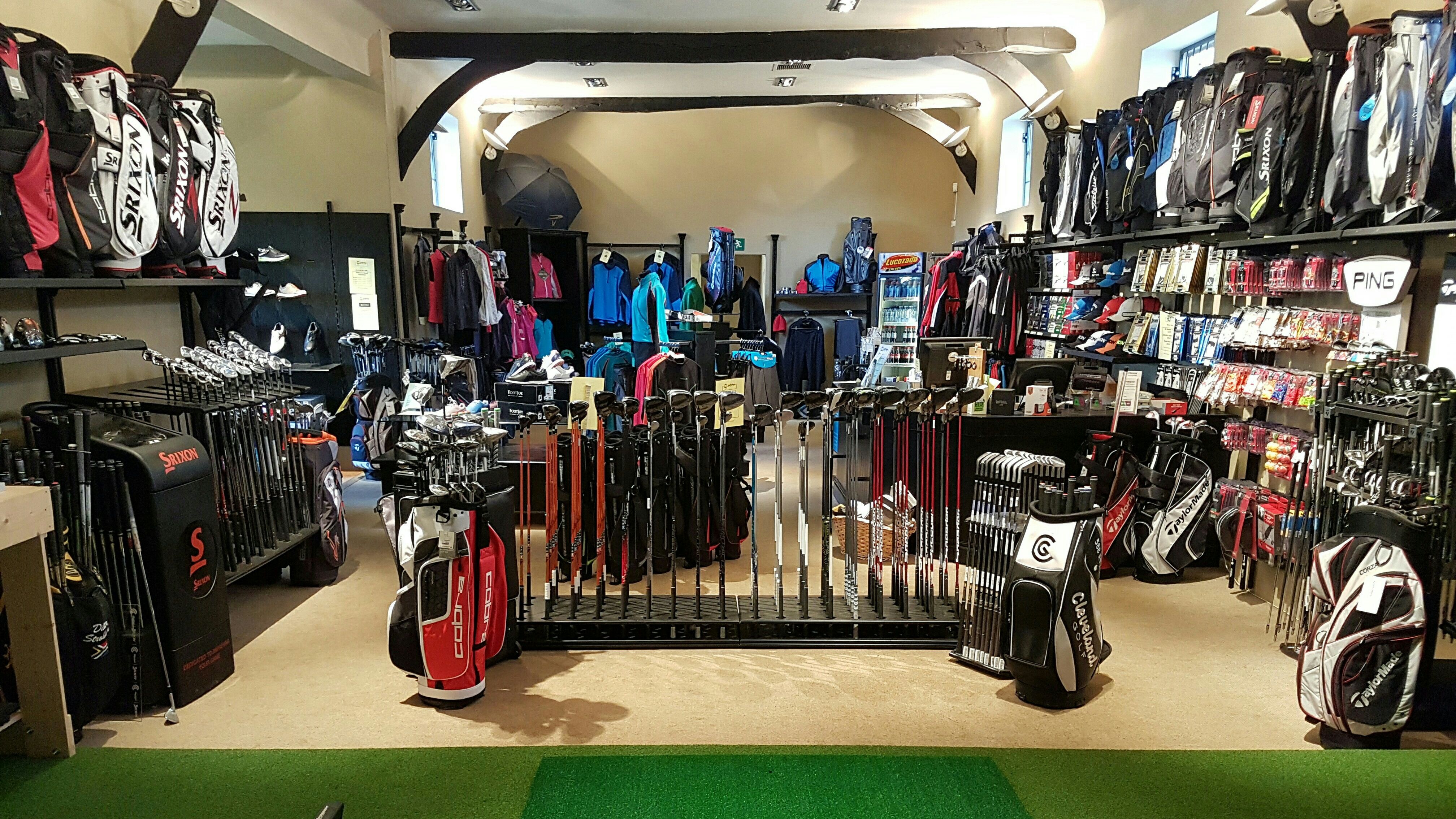 Golf shop interior with clubs, bags, and clothing on display