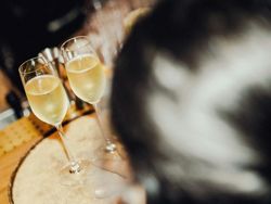 Two glasses of champagne on a wooden bar table