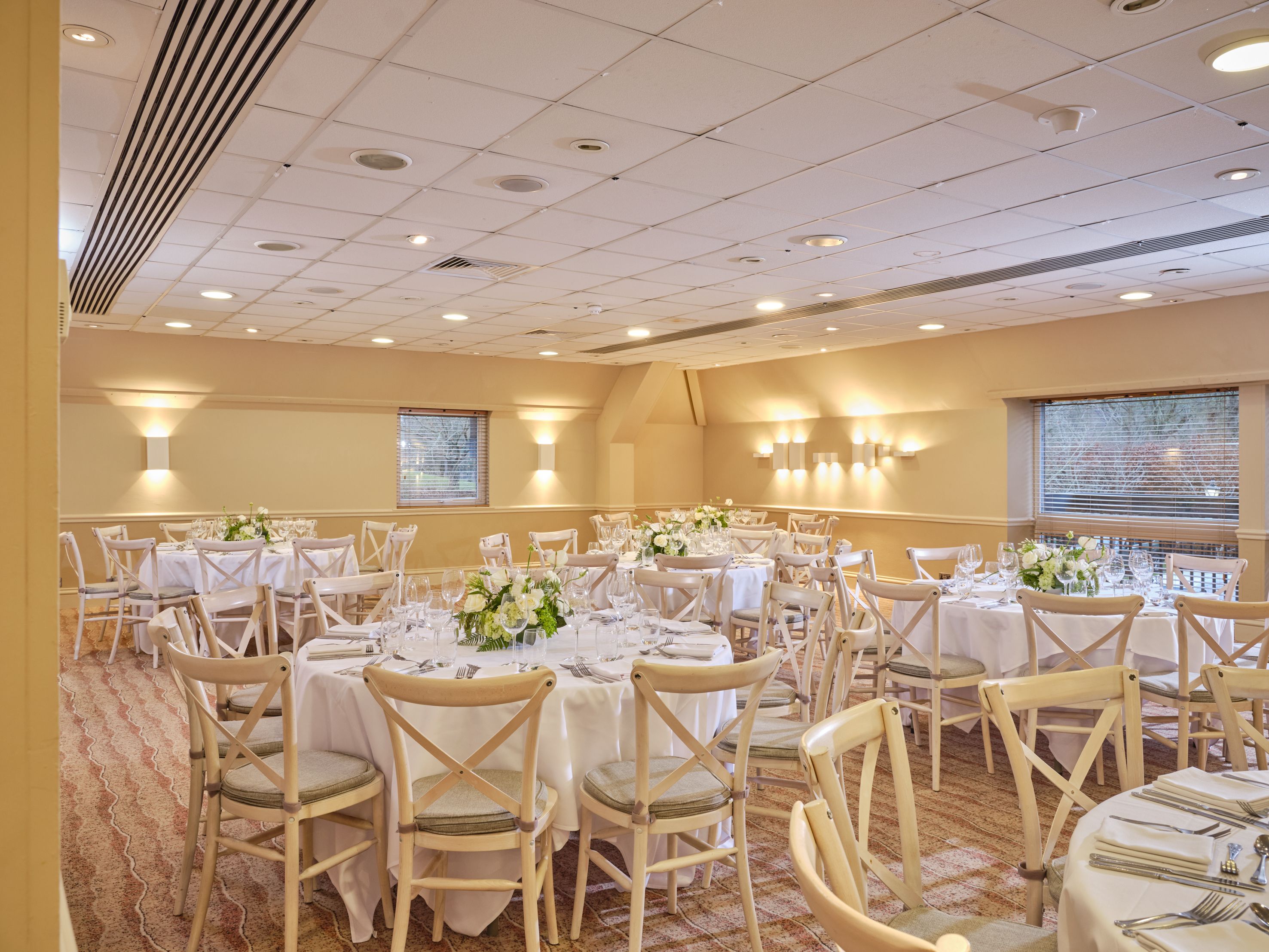 Elegant conference or banquet room with round tables set for a formal event