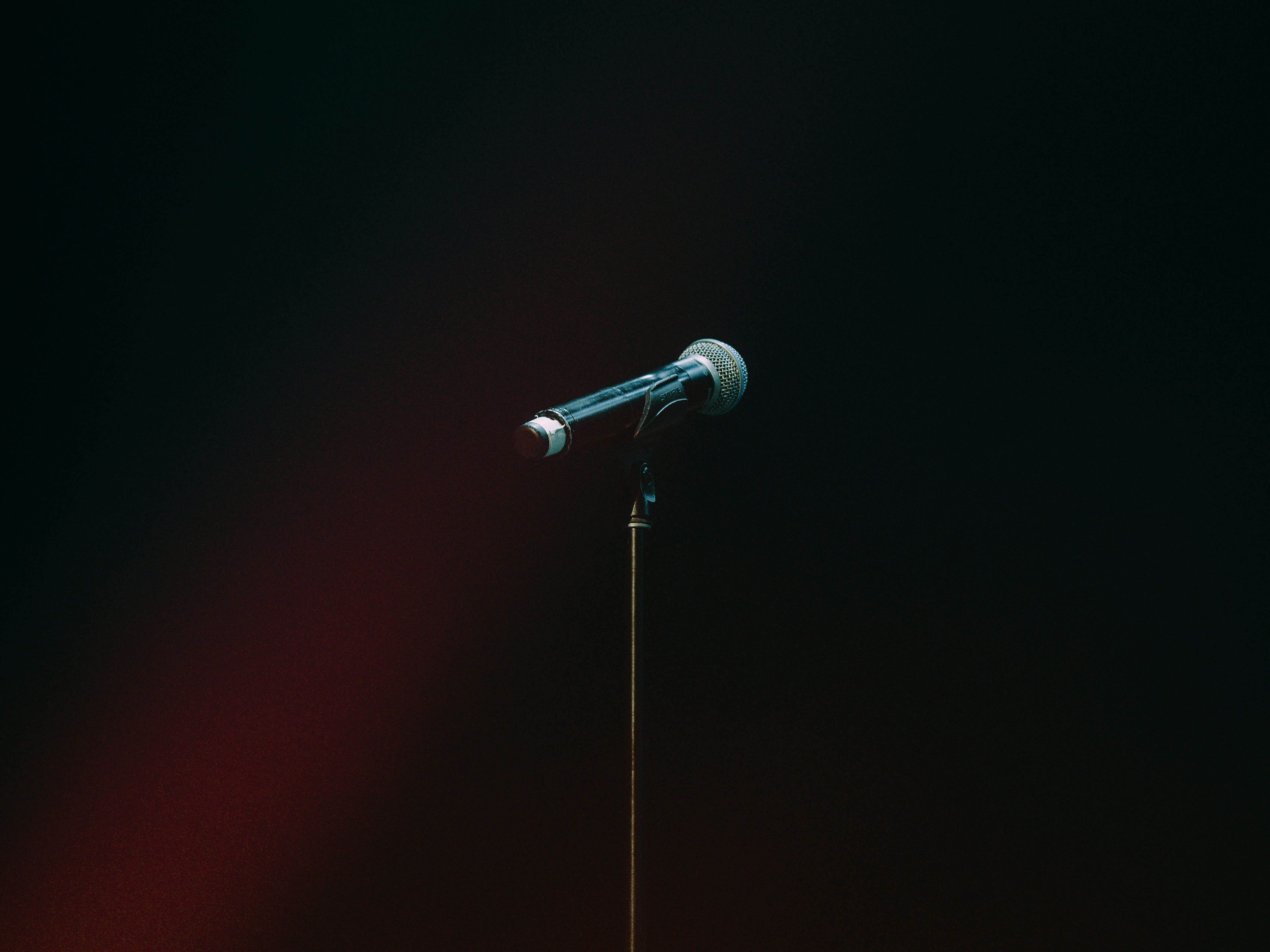 Microphone on a stand in a dark, empty space