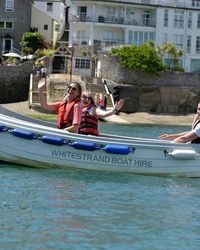 A small white motorboat labeled 