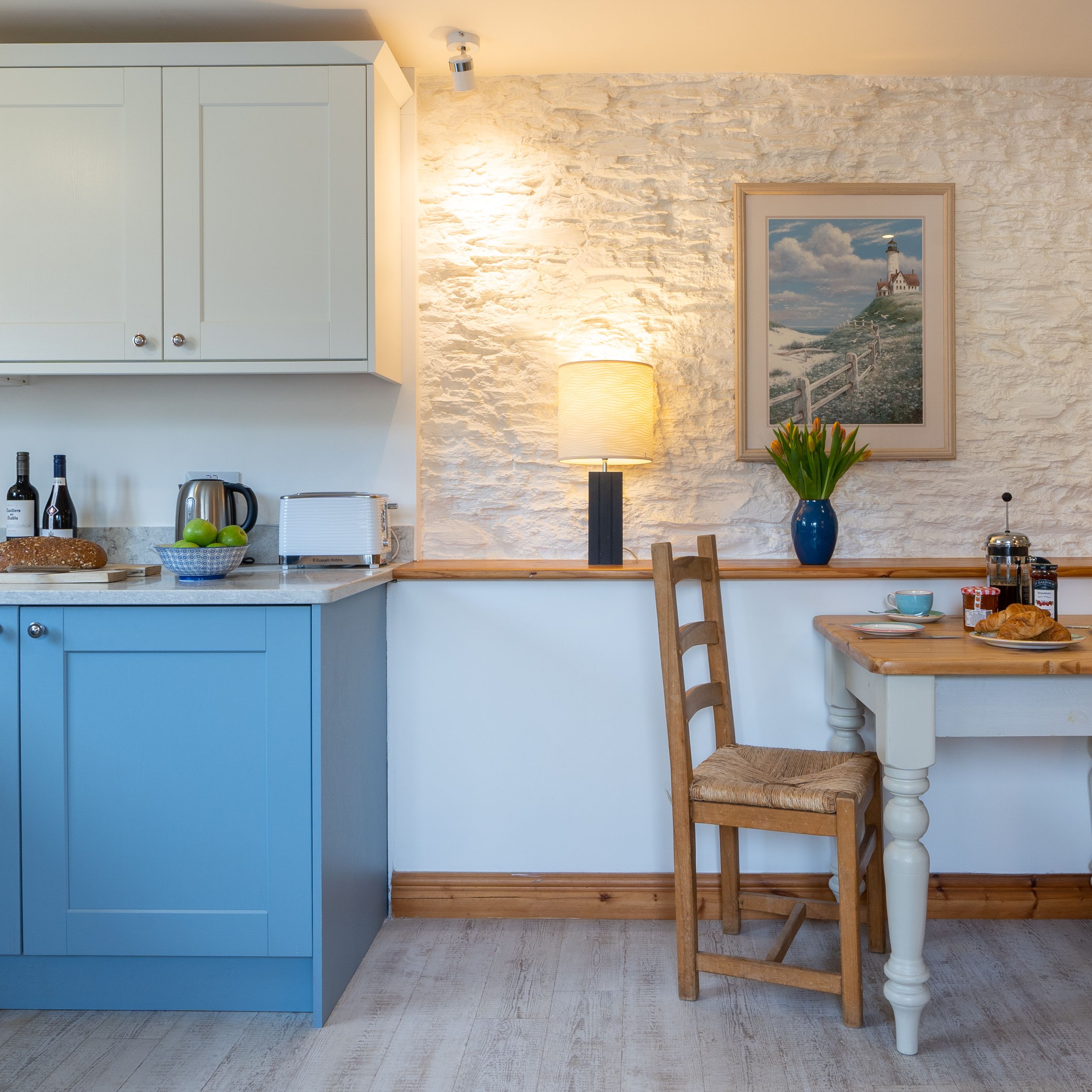 The dairy kitchen with blue cabinets and dining table