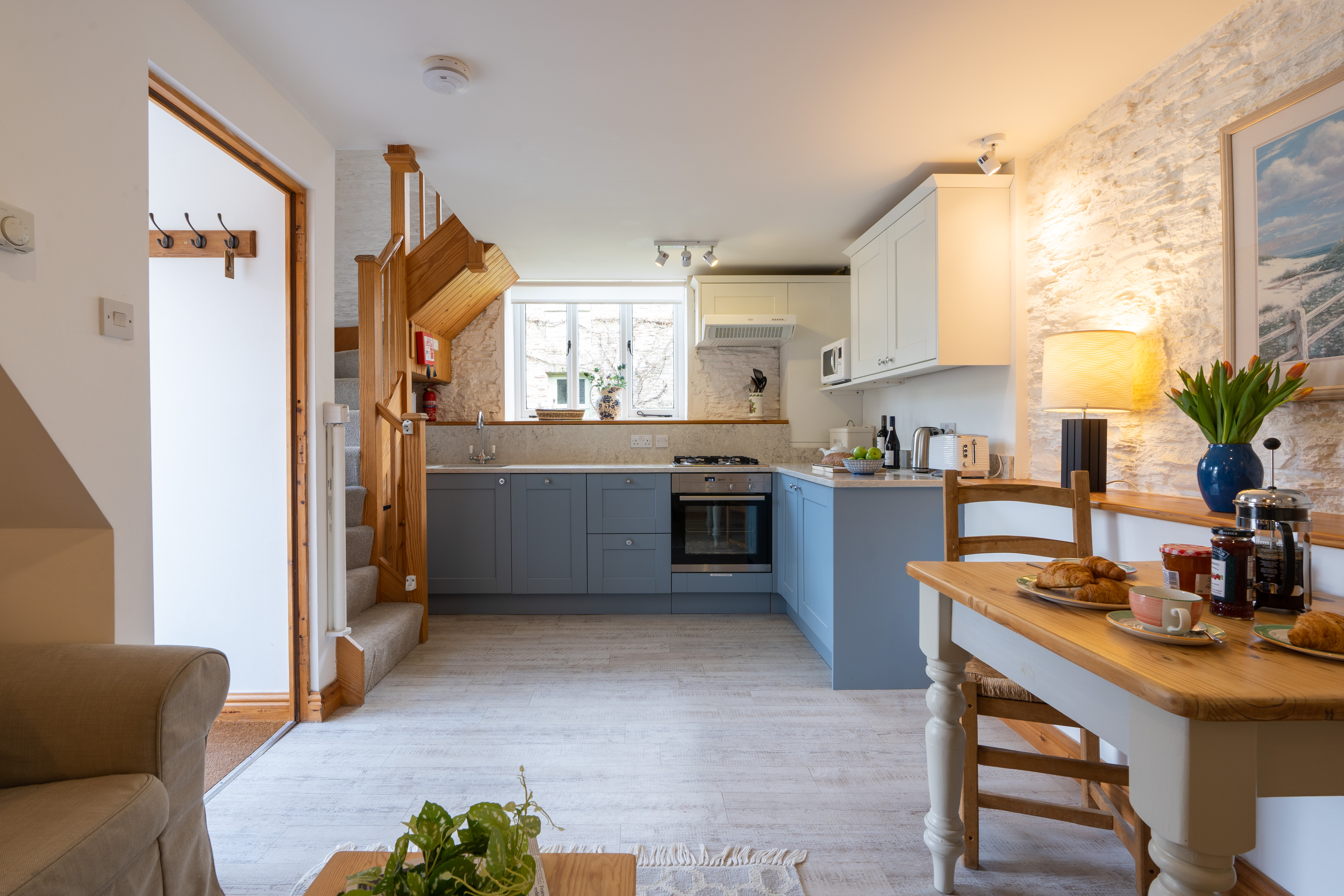 The dairy kitchen with blue cabinets and dining table