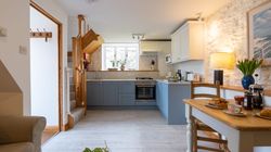 The dairy kitchen with blue cabinets and dining table