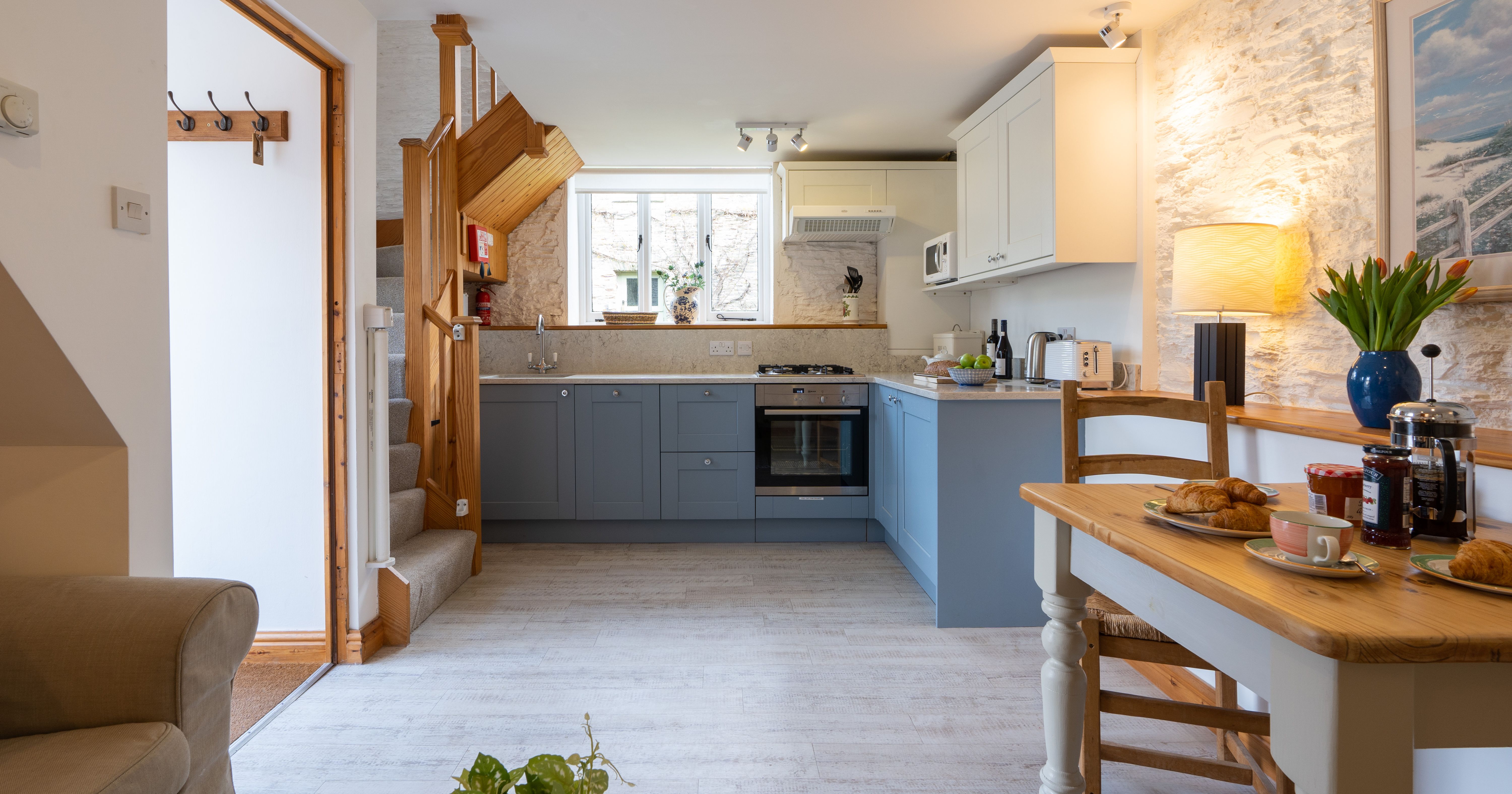 The dairy kitchen with blue cabinets and dining table