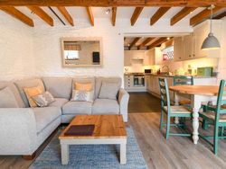 Quarry living area with exposed beams looking across to the kitchen