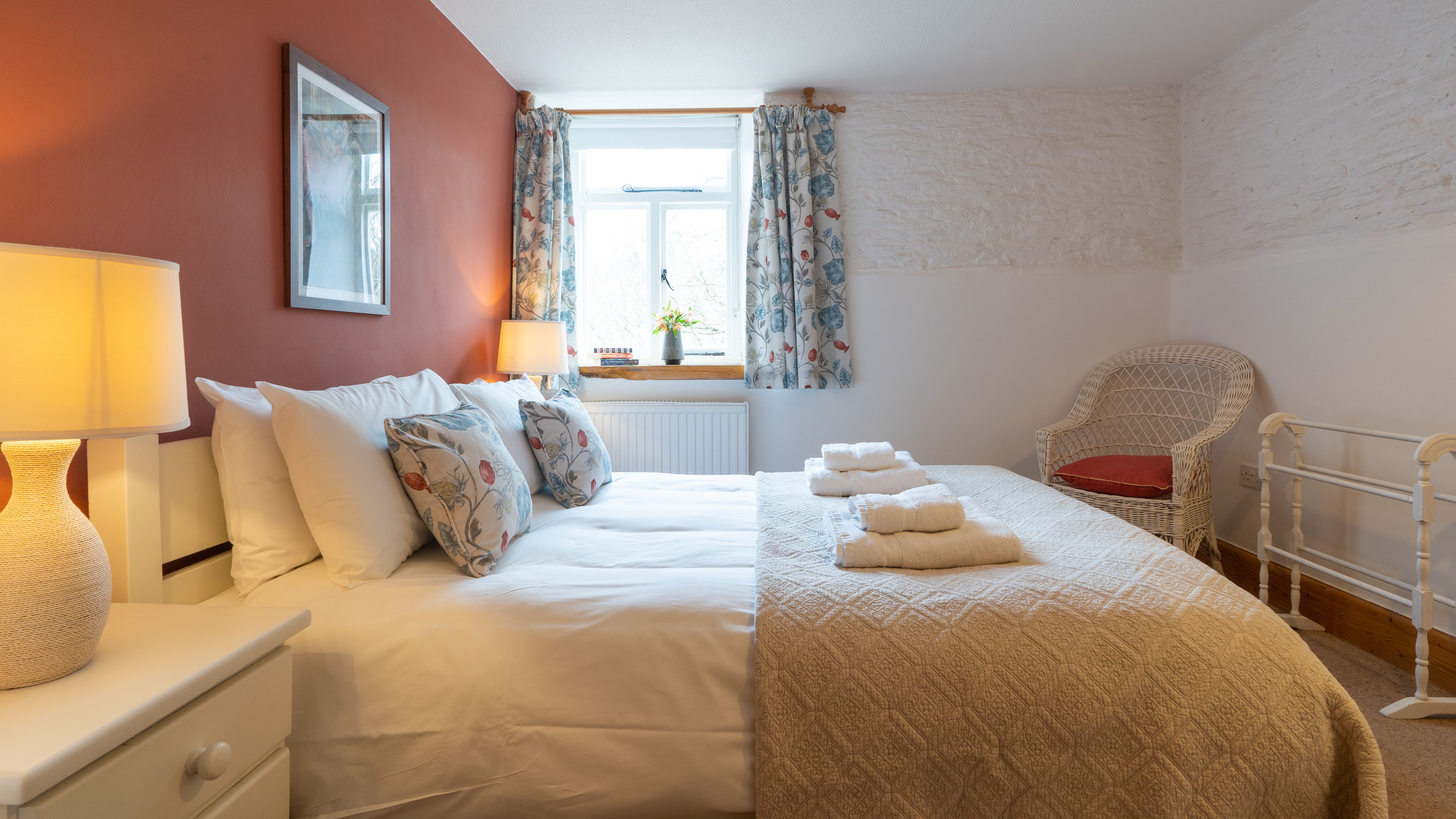 Stables main bedroom with terracotta colour feature wall