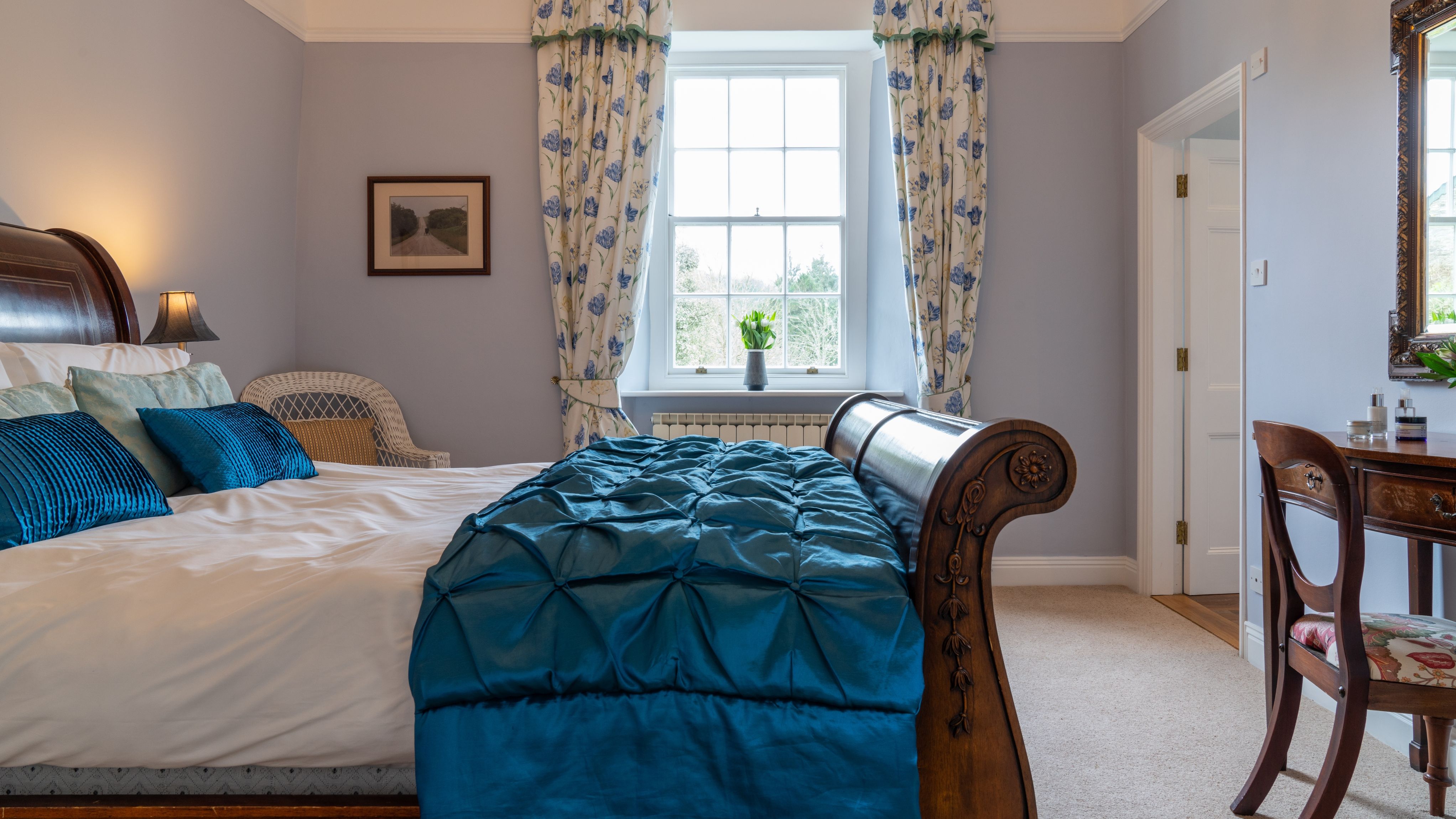 Overall room with traditional bed and blue cover