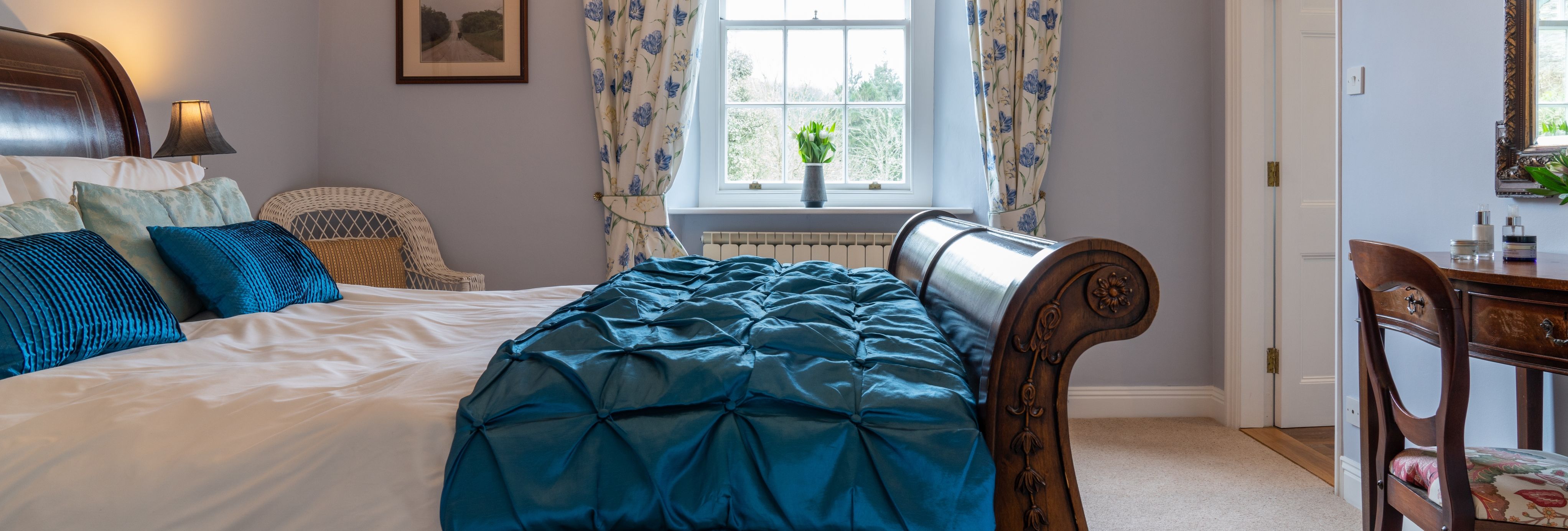 Overall room with traditional bed and blue cover