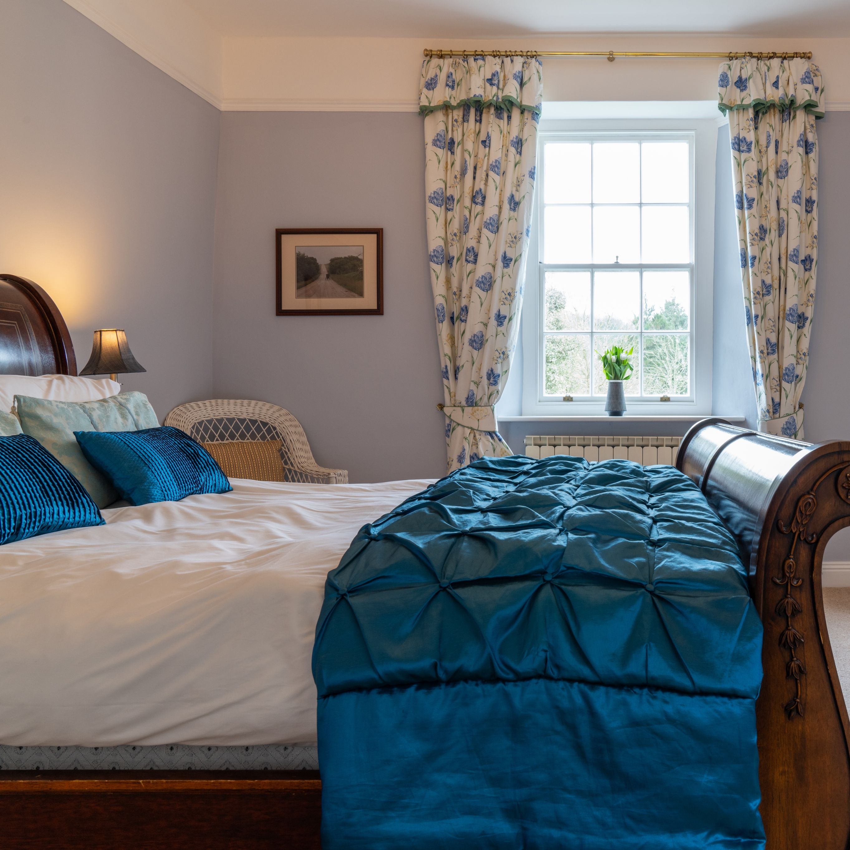Overall room with traditional bed and blue cover