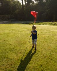 Child holding flag on Pitch and Putt