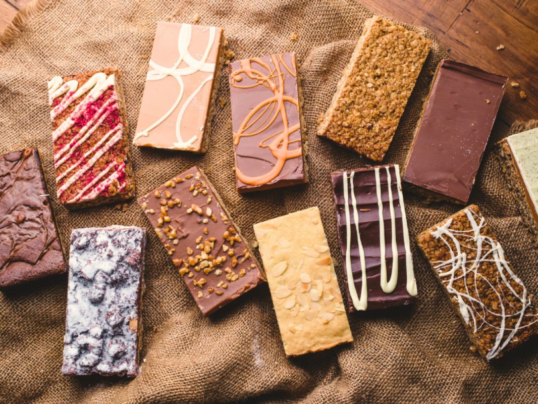 Assorted chocolate and cereal bars on a rustic hessian cloth