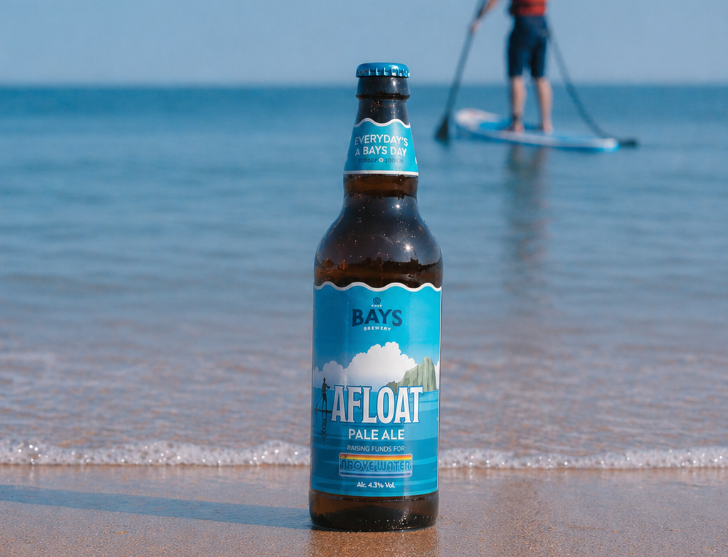 beer bottle on sandy beach Afloat brand from bays brewery